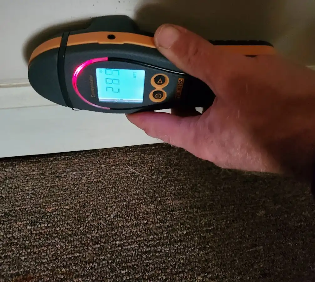 Moisture detection at baseboard during Storm Damage Restoration in Wake Forest